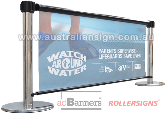 Two crowd tension barriers with sign banner advertising
